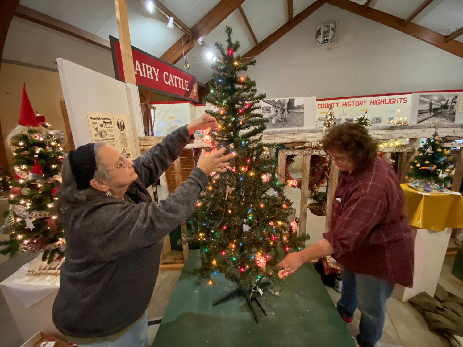 Walton sisters Kathy Brown and Mary Torma Kelly decorate their “Grandma’s Gingerbread” tree on Sunday, Nov. 26. They have been decorating a tree for the annual raffle for 18 years.